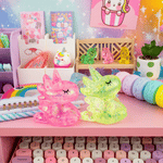 Two Unicorn Gummy Friends rock back and forth on a colorful desktop scene.