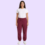 An adult wears the Maroon Adult Sensory Friendly Fidget Joggers.