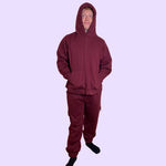 An adult wears the Maroon Adult Sensory Friendly Fidget Joggers.