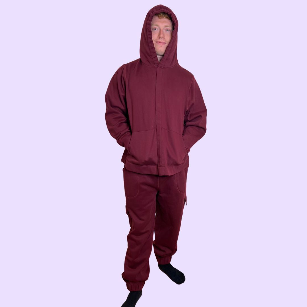 An adult wears the Maroon Adult Sensory Friendly Fidget Joggers.