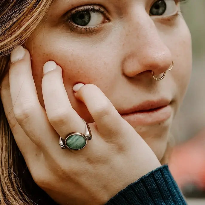 The Amazonite Crystal Spinner on a CONQUERing Classic Base, worn on a ring finger.