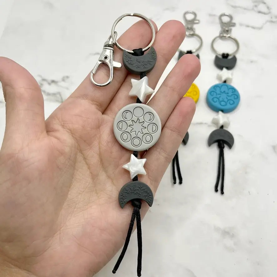 The grey Moon Phases Chewy Fidget Keychain.