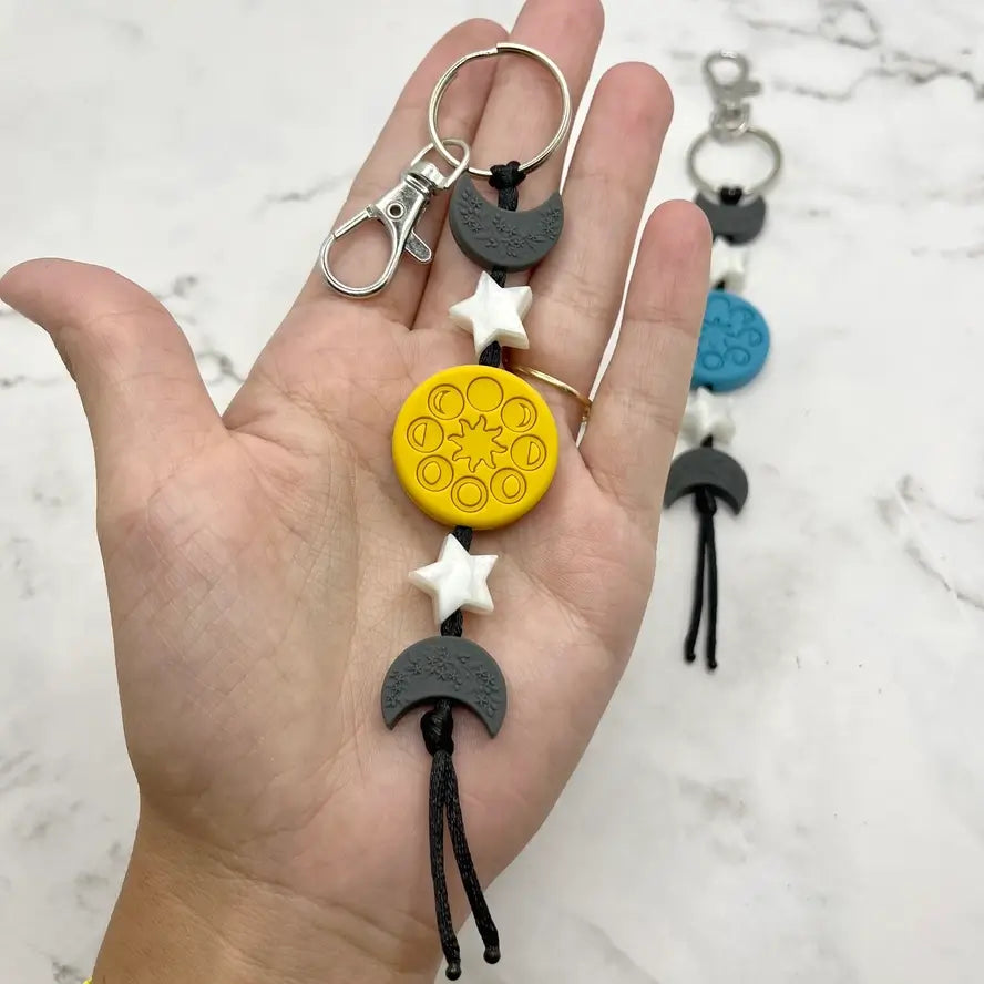 The yellow Moon Phases Chewy Fidget Keychain.