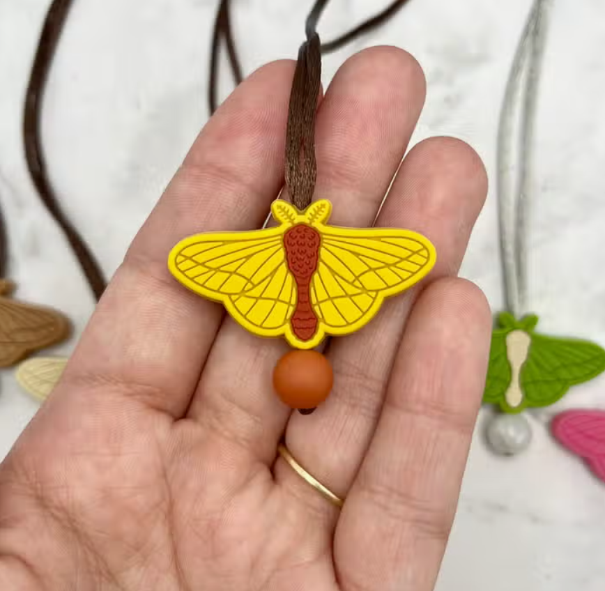 The yellow Moth Fidget Chewable Jewelry Necklace.