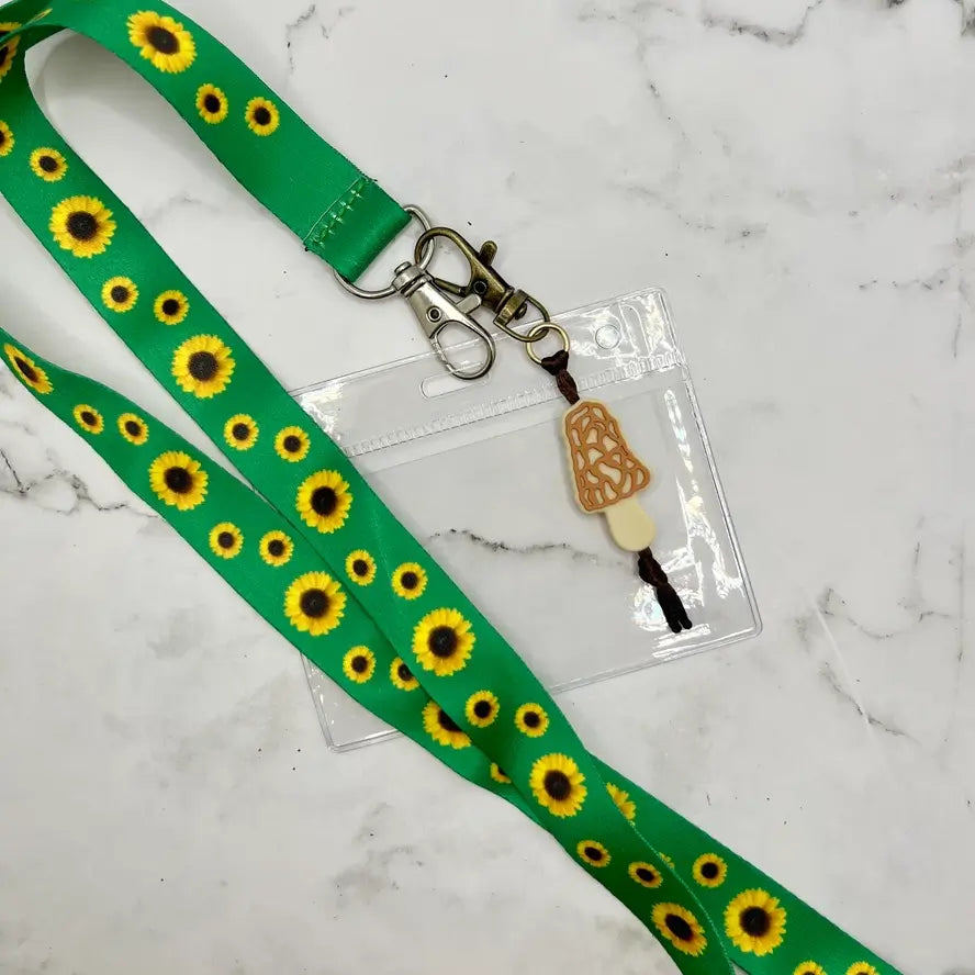 A lanyard with sunflowers is attached to the Morel Chewy Fidget Zipper Pull/Keychain.