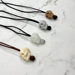 The four different colors of the Skull Fidget Chewable Jewelry Necklace for Adults. 