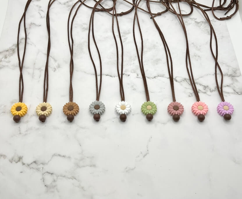 Several varieties of the Small Flower Silicone Chewy Fidget Necklace.