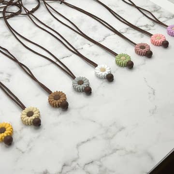 Several varieties of Small Flower Silicone Chewy Fidget Necklace.