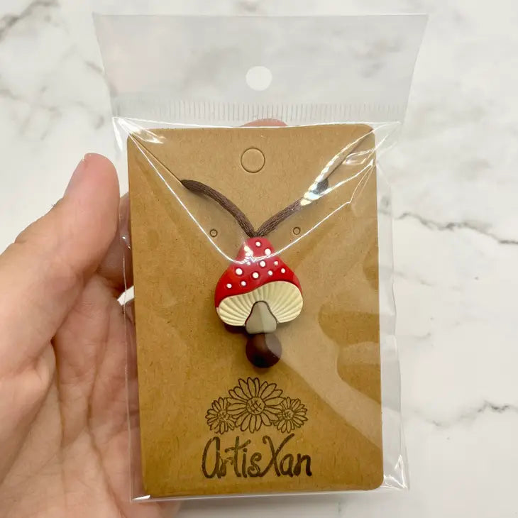 The product package for the red Spotted Mushroom Fidget Chewable Jewelry Necklace.