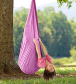 A child leans backwards out of a purple HugglePod Lite Nylon Hanging Chair.