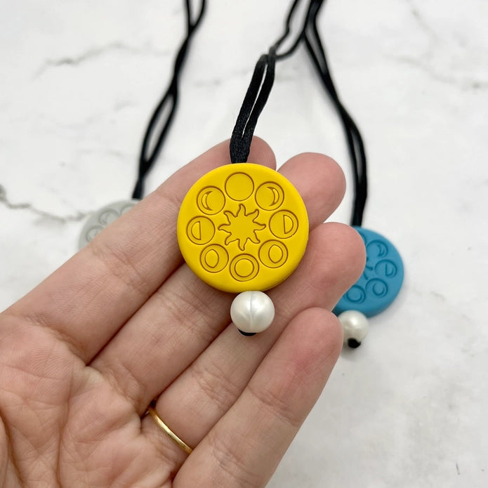 The yellow Moon Phases Fidget Necklace.