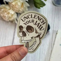 The Unclench Your Jaw sticker.