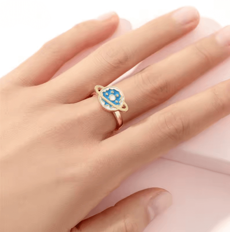 A hand models the Blue Ringed Planet Fidget Spinner Ring.