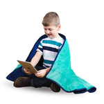 A child looks at a tablet while wrapped in the Bouncyband Kids Soft Fleece Sensory Weighted Blanket - 7 lb.