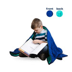A child looks through a school book while wrapped in the Bouncyband Kids Soft Fleece Sensory Weighted Blanket - 7 lb.