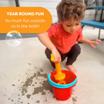 A child puts the Bubble Bath Whisk in a bucket on an outside patio and makes a splash.