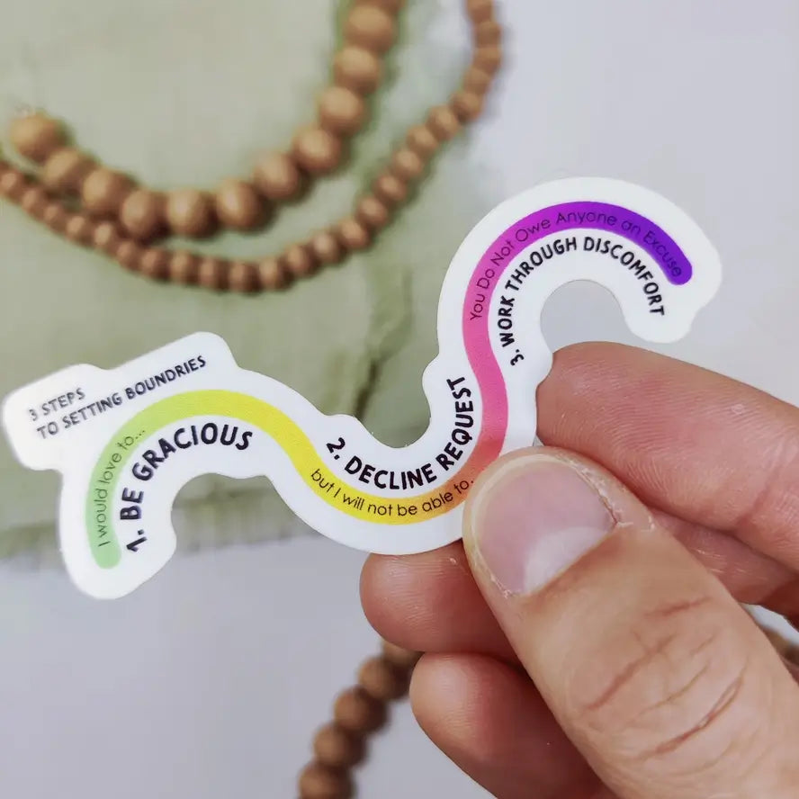 A hand holds the Setting Boundaries Vinyl 3" Sticker.