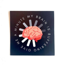A sticker with a brain overimposed on a buffering circle that says: Give Me a Minute My Brain is Buffering.