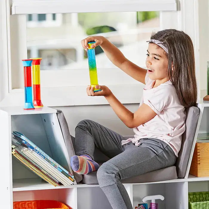 A child holding up a Colormix Sensory Tube.