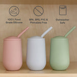 Three different colors of the EZPZ Happy Cup + Straw System for Toddlers.
