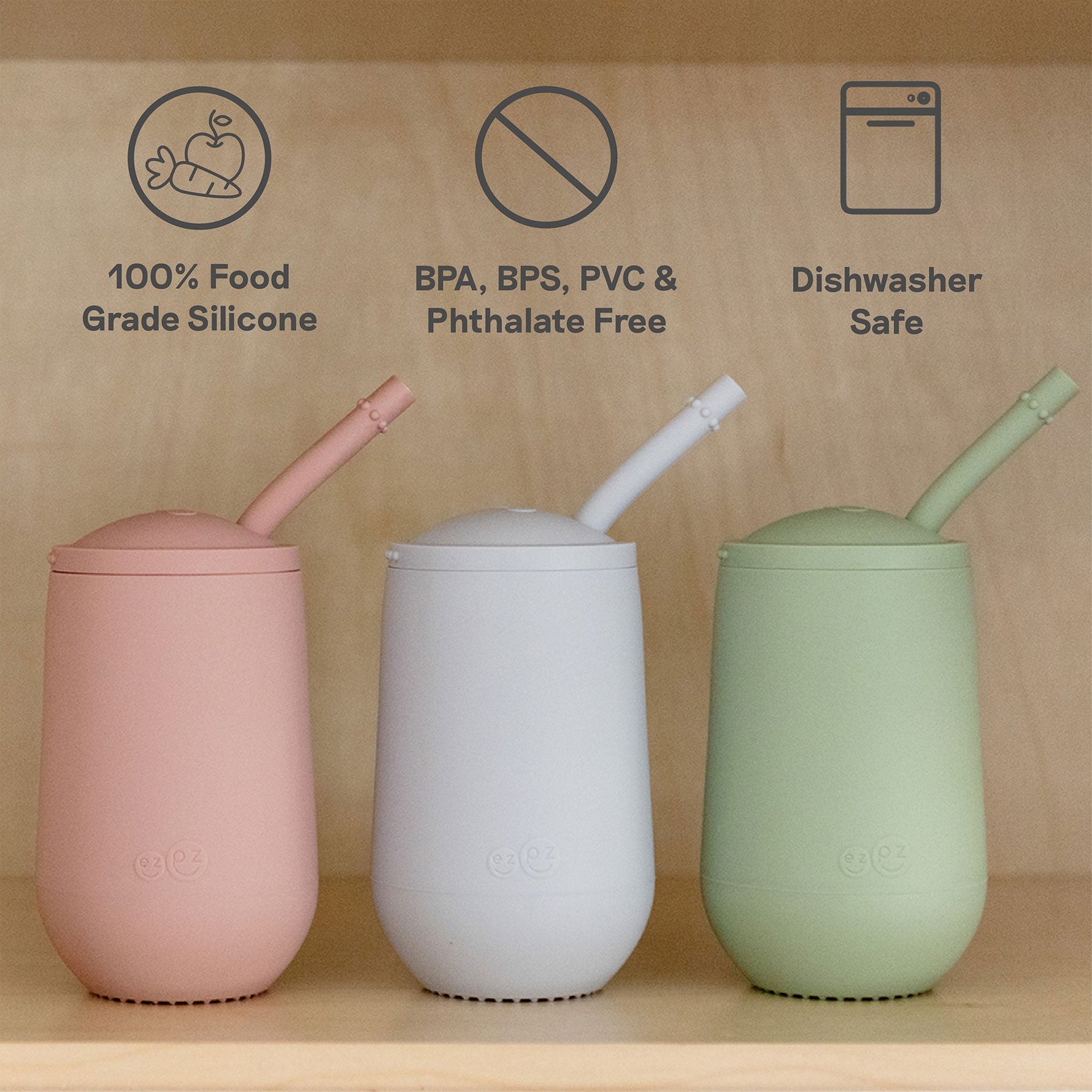 Three different colors of the EZPZ Happy Cup + Straw System for Toddlers.