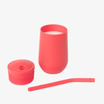 The three separate components of the EZPZ Coral Cup + Straw System for Toddlers.
