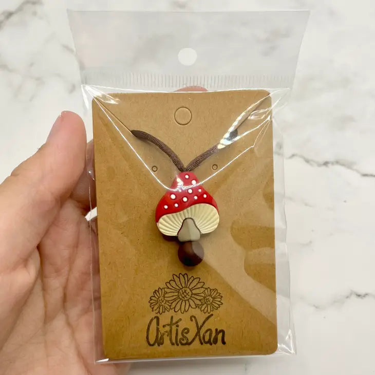 The product package for the Spotted Mushroom Chewy Fidget Necklace.