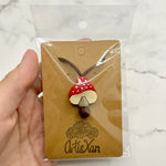 The product package for the Spotted Mushroom Chewy Fidget Necklace.