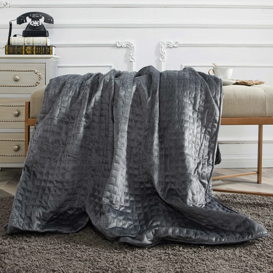 The Sutton Home Removable Washable Duvet Weighted Blanket 20 lb draped over a plush bench.