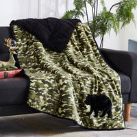 The Dream Theory Kids Applique Sherpa Weighted Throw 6 lb thrown over a black couch.