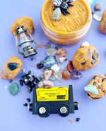 Several polished rocks and crystals sit in the middle of the picture surrounded by other elements of the kit. 