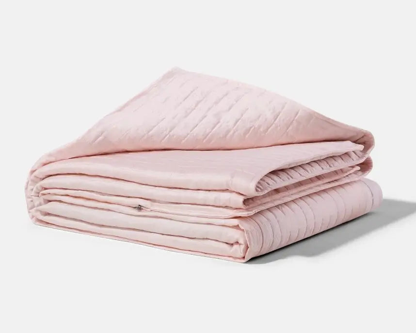 The pink Gravity Cooling Weighted Blanket (20 lbs).