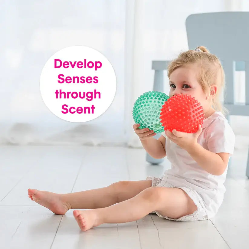 A child holds both spiky balls and text reads: develop senses through scent.