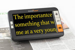 The explore 5 sits on a newspaper and magnifies text.