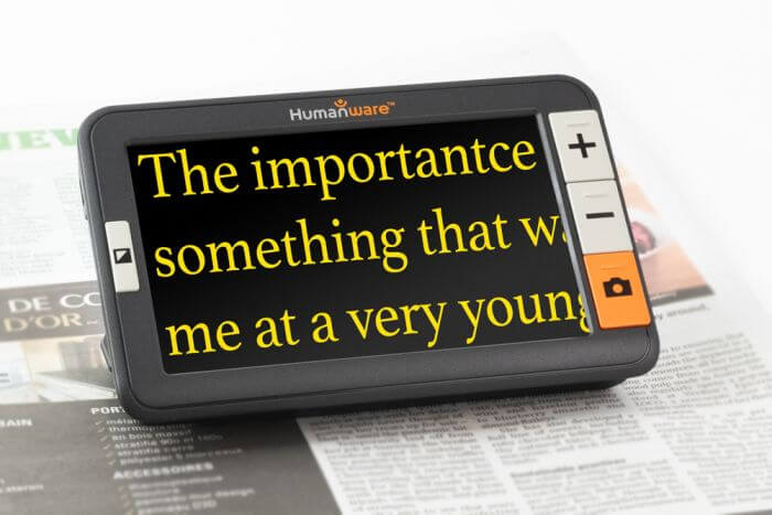 The explore 5 sits on a newspaper and magnifies text.