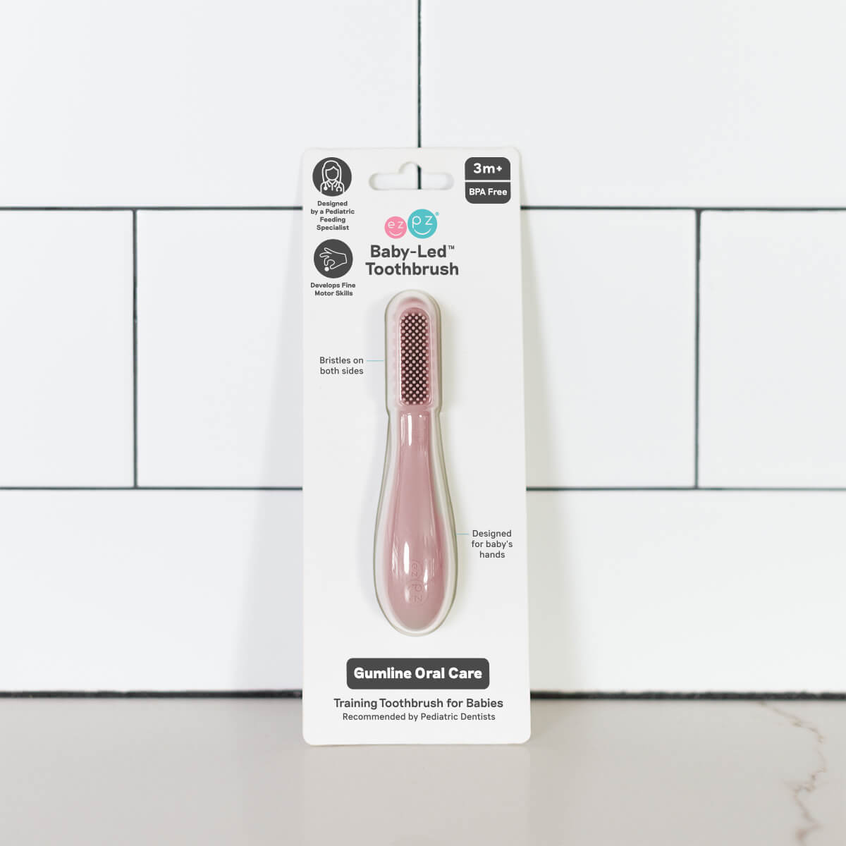 The Blush ezpz Baby-Led Toothbrush in its product packaging.