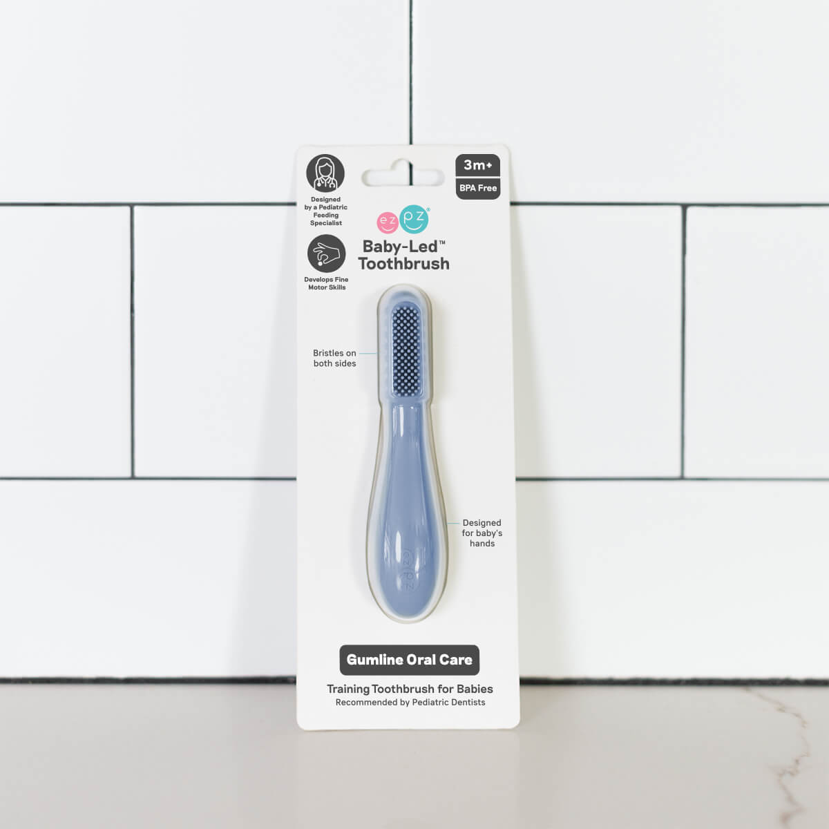 The Indigo ezpz Baby-Led Toothbrush in its product package.