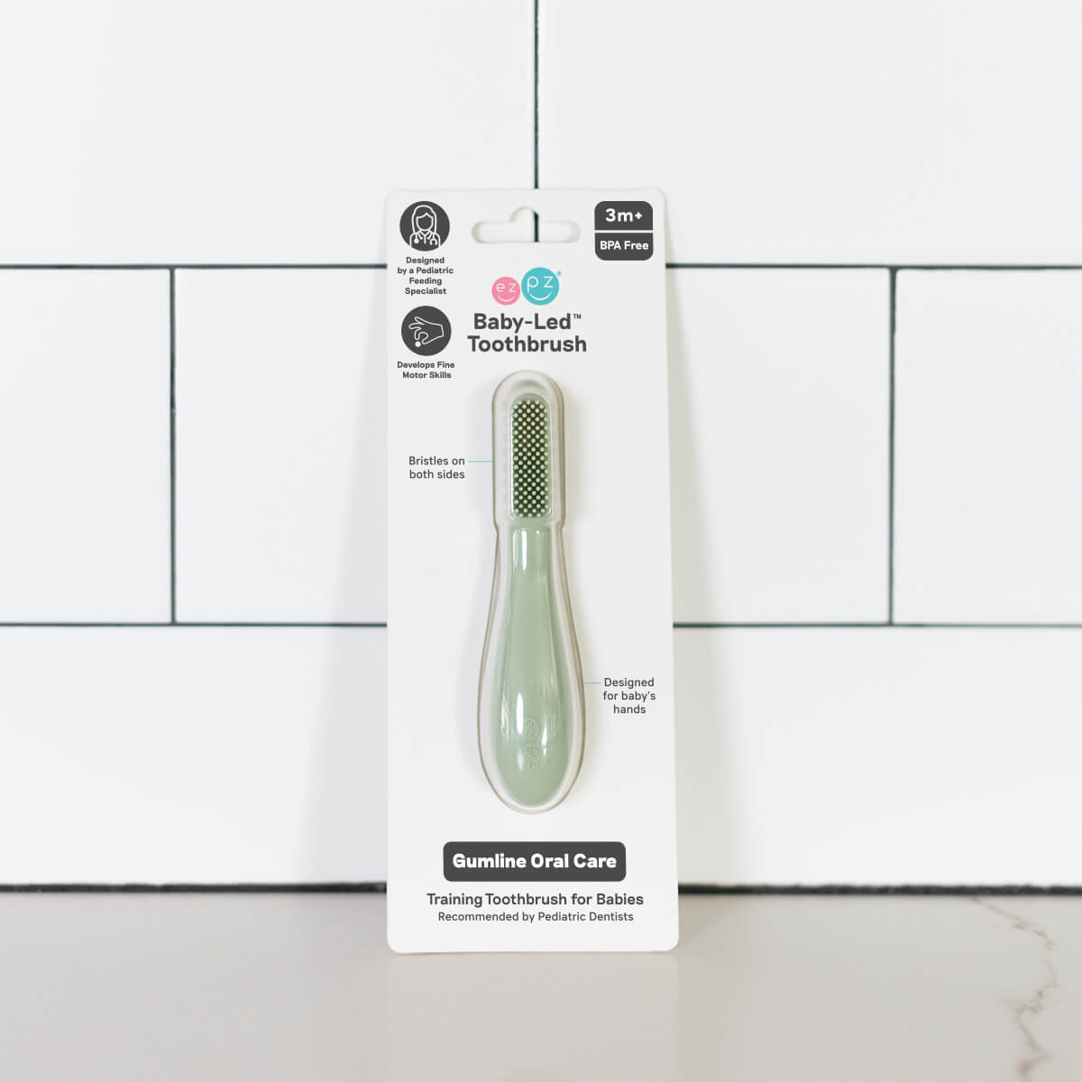 The Sage ezpz Baby-Led Toothbrush in its product package.