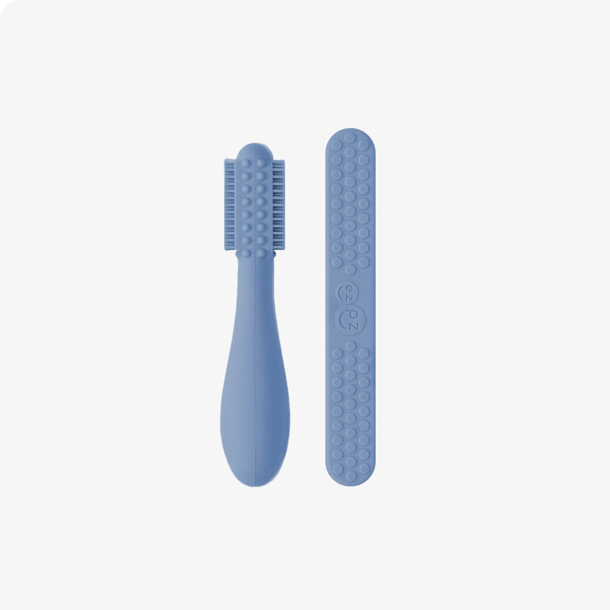 The back of the Indigo ezpz Baby-Led Toothbrush and Tongue Depressor Combo.
