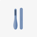The Indigo ezpz Baby-Led Toothbrush and Tongue Depressor Combo.