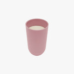 The cup portion of the Blush 14 oz Cup + Lid, full of milk.