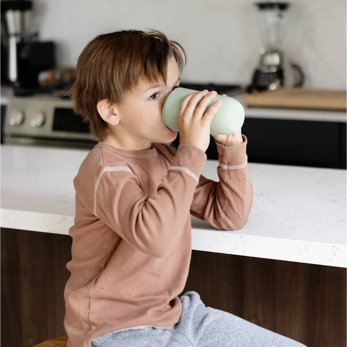 A child drinks from the Sage Cup.