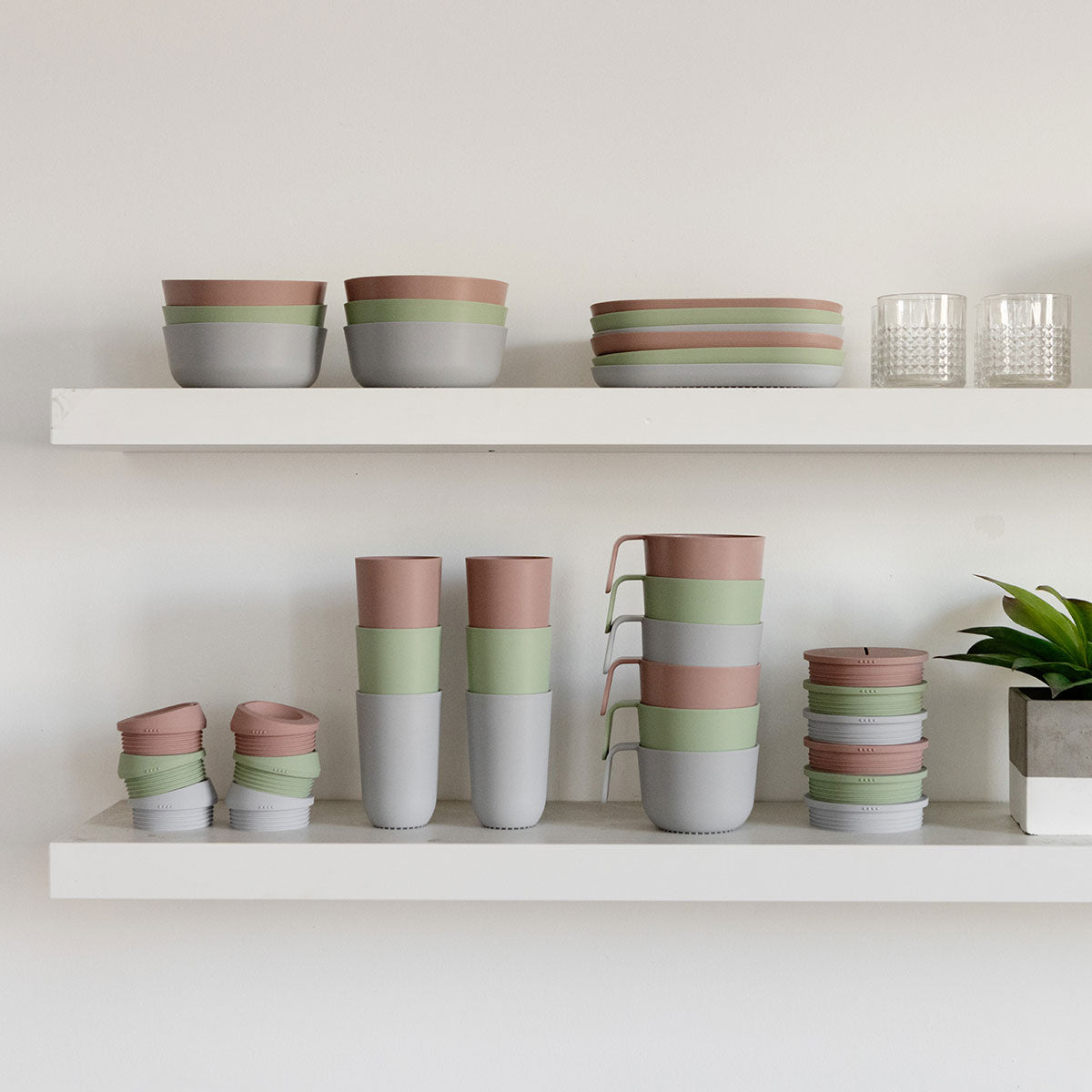 Several Blush, Sage, and Pewer cups and lids are stacked in a visually appealing way.