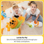 Two children look up from the floor as an Air Toobz Toobzter flies up towards the ceiling.