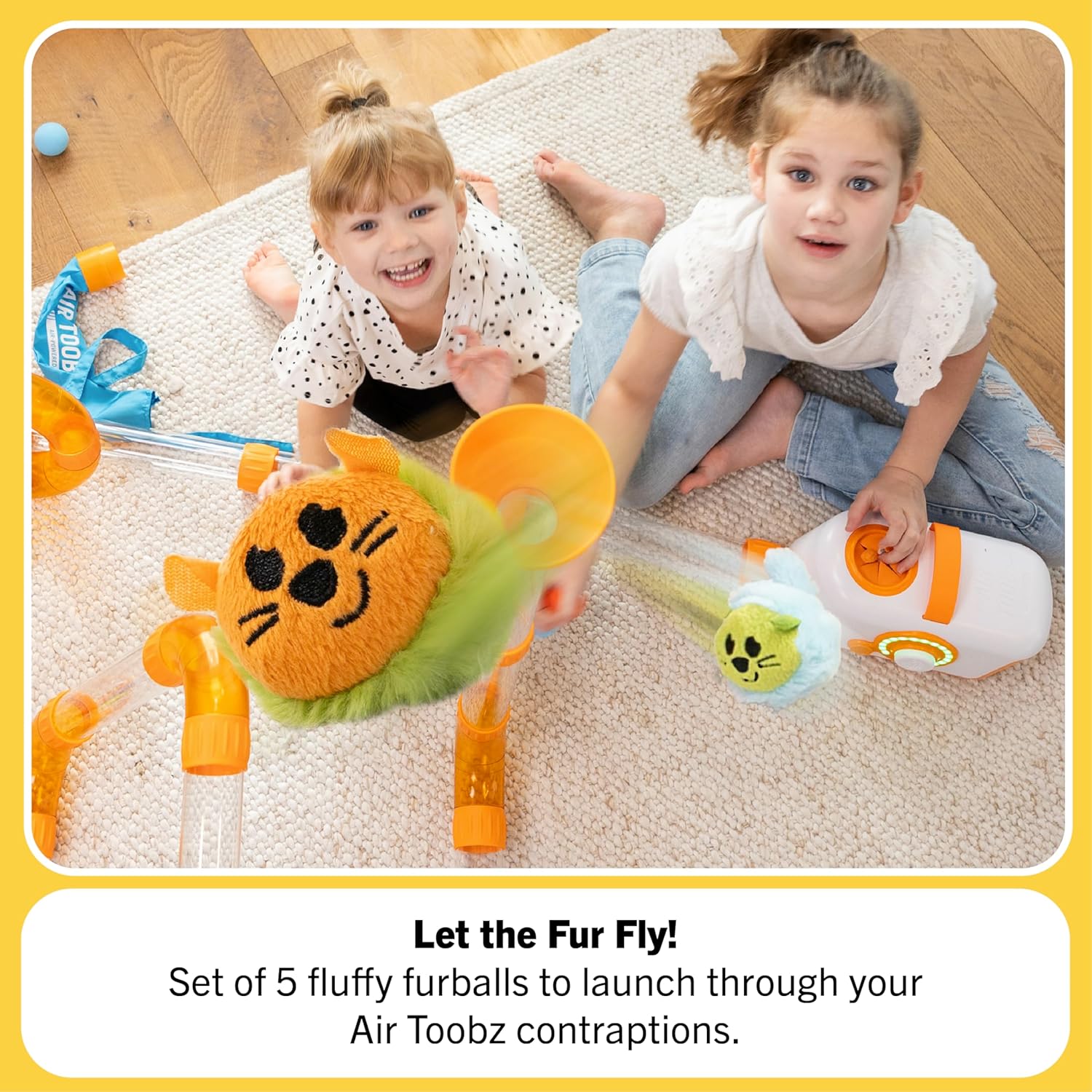 Two children look up from the floor as an Air Toobz Toobzter flies up towards the ceiling.
