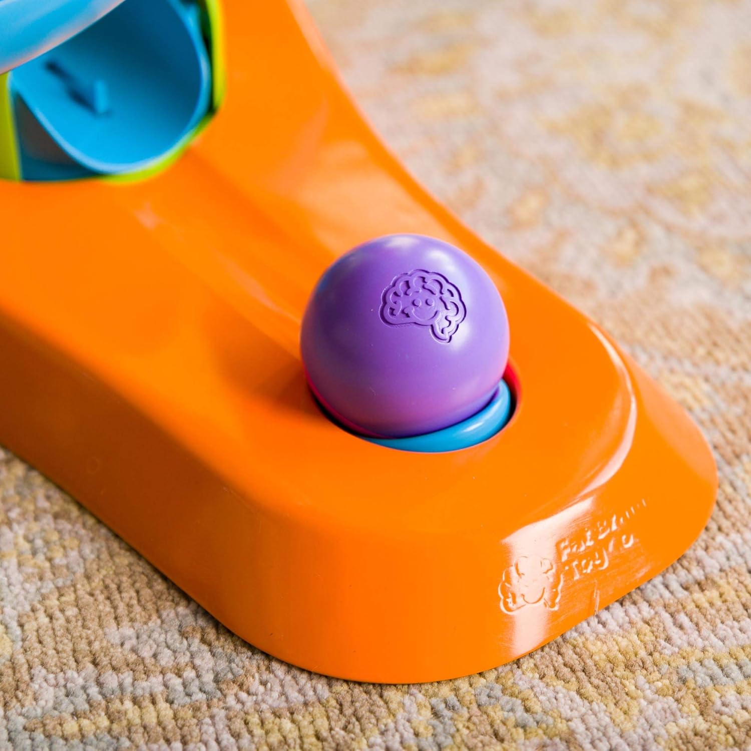 A purple ball rests on the bottom of the RollAgain Tower.