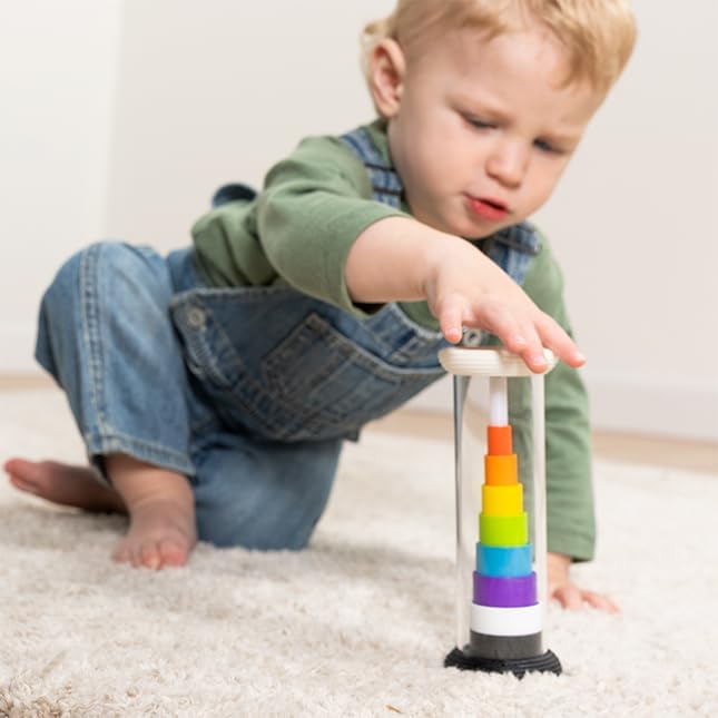 A child moves across the carpet and reaches for a Flipty.