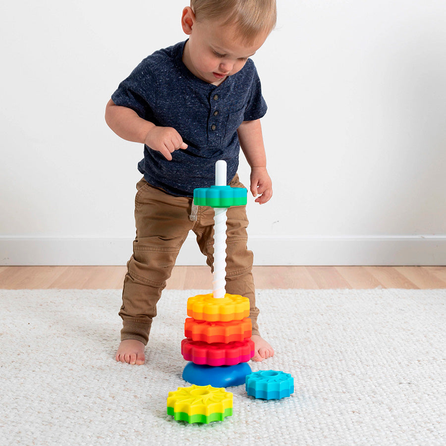 A child standing over the SpinAgain as one piece drops down the tower.
