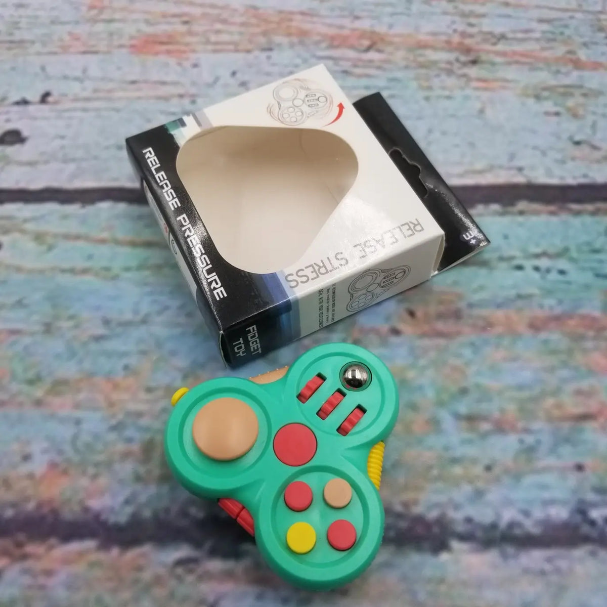 The green Fidget Pad 12-in-1 Fidget Controller.