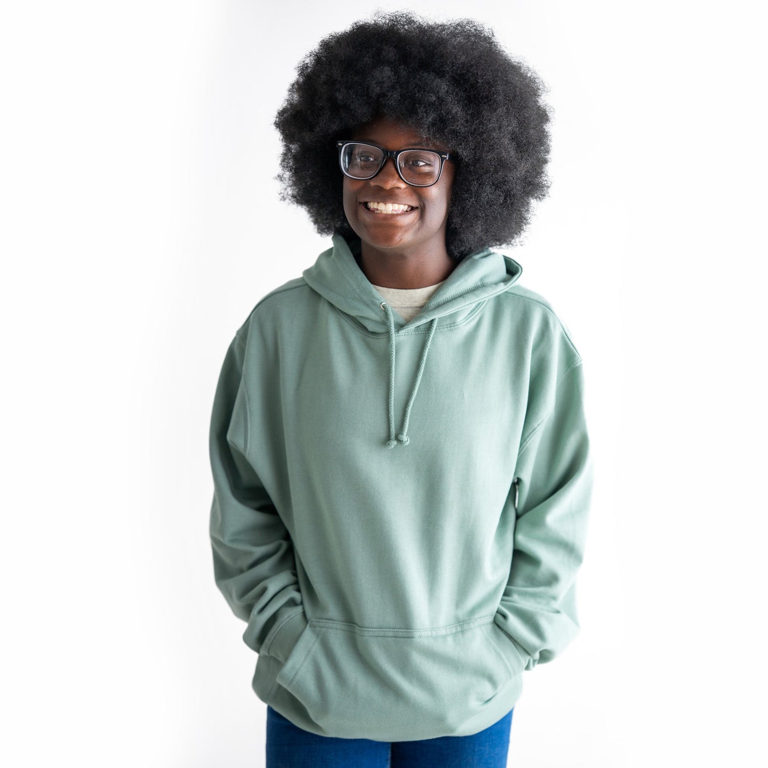 An adult wears the Serene Sage Fidget Hoodie with their hands in the front pockets.